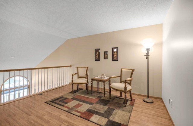 12626 43rd St NE, Saint Michael, MN 55376 - sitting room with light wood finished floors, lofted ceiling, and baseboards