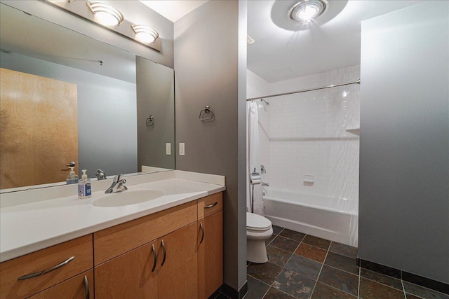 401 2nd St N Unit 220, Minneapolis, MN 55401 - full bathroom featuring stone tile floors, toilet, vanity, and shower / bath combo with shower curtain