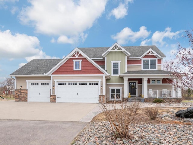 11460 Eagle Creek Ln, Rogers, MN 55374 - craftsman-style home featuring covered porch, concrete driveway, stone siding, roof with shingles, and an attached garage