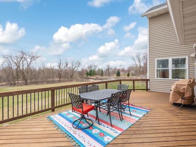 11460 Eagle Creek Ln, Rogers, MN 55374 - wooden deck with outdoor dining space, a lawn, and grilling area