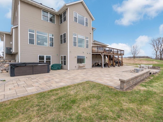 11460 Eagle Creek Ln, Rogers, MN 55374 - back of property with a hot tub, a patio area, a deck, a lawn, and stairs