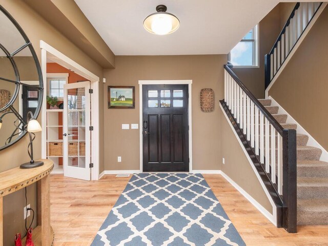 11460 Eagle Creek Ln, Rogers, MN 55374 - entryway featuring baseboards, wood finished floors, and stairway