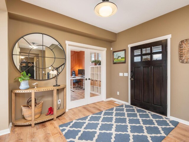 11460 Eagle Creek Ln, Rogers, MN 55374 - entrance foyer featuring french doors, wood finished floors, and baseboards