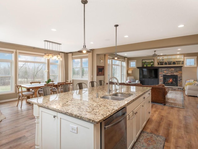 11460 Eagle Creek Ln, Rogers, MN 55374 - kitchen with a sink, stainless steel dishwasher, an island with sink, light wood-type flooring, and white cabinets