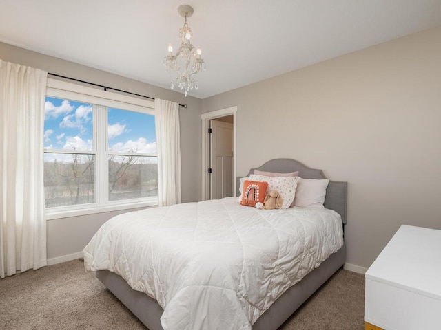 11460 Eagle Creek Ln, Rogers, MN 55374 - carpeted bedroom with baseboards and a chandelier