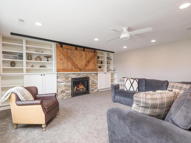 11460 Eagle Creek Ln, Rogers, MN 55374 - living area with carpet, recessed lighting, a ceiling fan, a textured ceiling, and a fireplace