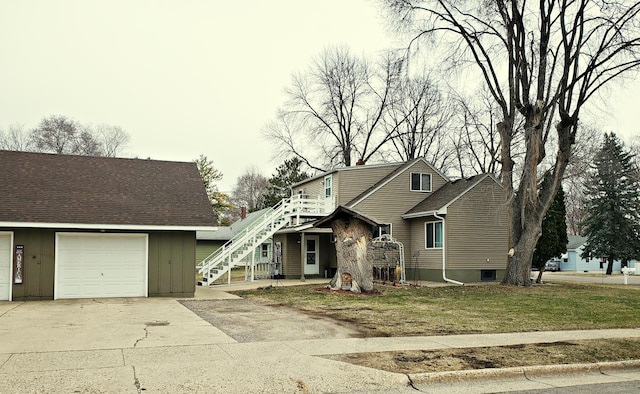 view of front facade featuring stairway, board and batten siding, and concrete driveway