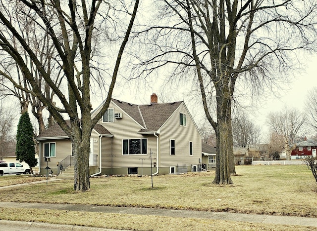 view of home's exterior featuring a lawn and a chimney