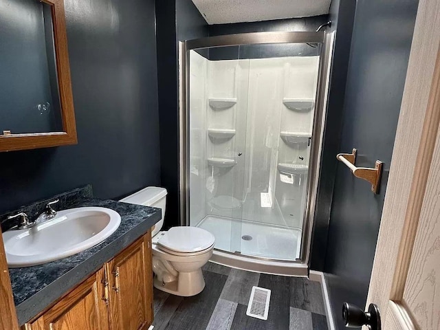 720 2nd St E, Lake Lillian, MN 56253 - full bath featuring visible vents, a shower stall, wood finished floors, vanity, and toilet
