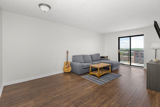 living area with baseboards and wood finished floors
