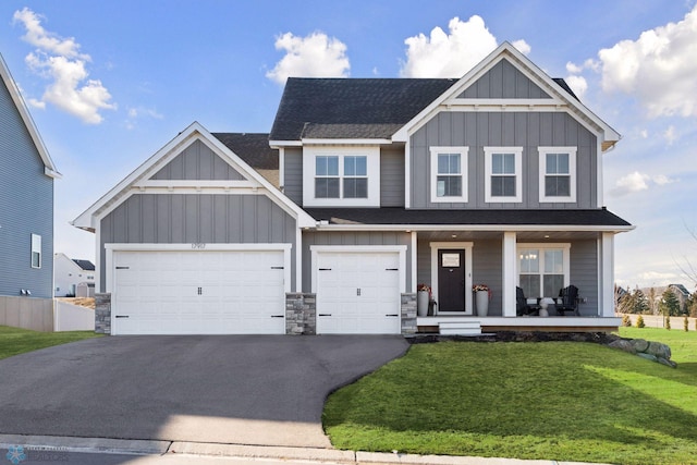 17917 Hayes Ave, Lakeville, MN 55044 - craftsman-style house with a front lawn, stone siding, covered porch, board and batten siding, and aphalt driveway
