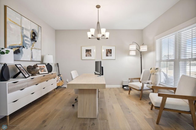 17917 Hayes Ave, Lakeville, MN 55044 - office area featuring baseboards, light wood-style floors, and a chandelier