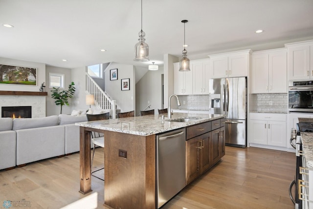 17917 Hayes Ave, Lakeville, MN 55044 - kitchen with a sink, open floor plan, stainless steel appliances, and light wood-type flooring