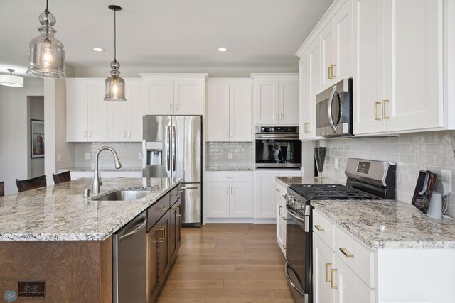 17917 Hayes Ave, Lakeville, MN 55044 - kitchen featuring white cabinets, a sink, recessed lighting, and appliances with stainless steel finishes