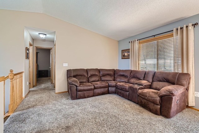 carpeted living room featuring a textured ceiling, lofted ceiling, and baseboards