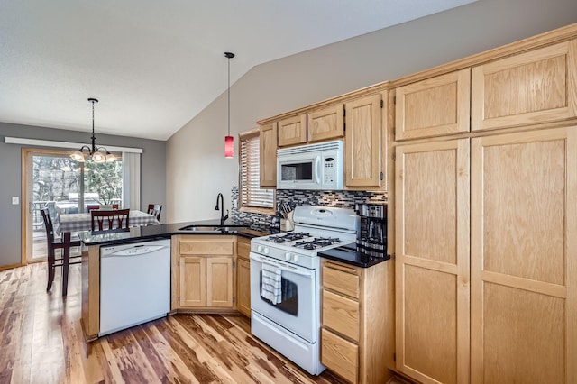 kitchen with light brown cabinetry, light wood-style flooring, a peninsula, white appliances, and lofted ceiling