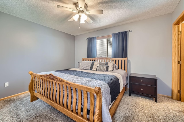 bedroom featuring a textured ceiling, carpet flooring, a ceiling fan, and baseboards