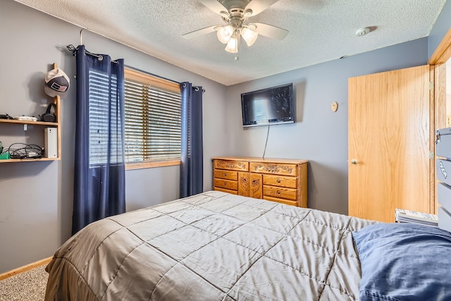 carpeted bedroom with a textured ceiling and a ceiling fan