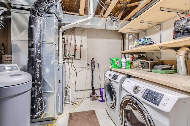 washroom with heating unit, separate washer and dryer, and laundry area