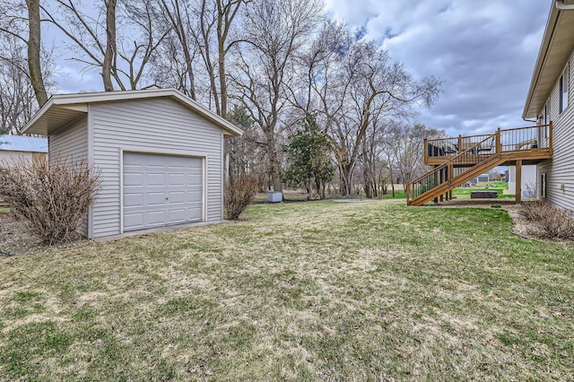 view of yard with a deck, stairs, and an outbuilding