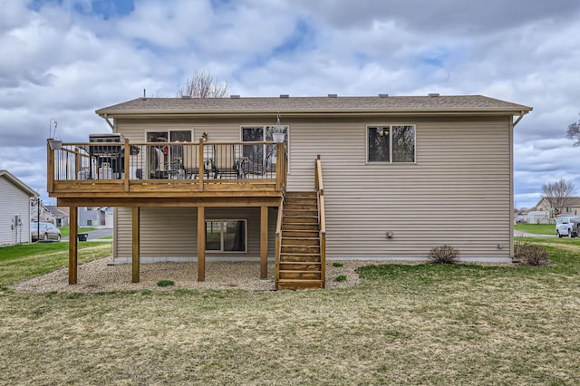 rear view of house with a yard, stairs, and a wooden deck