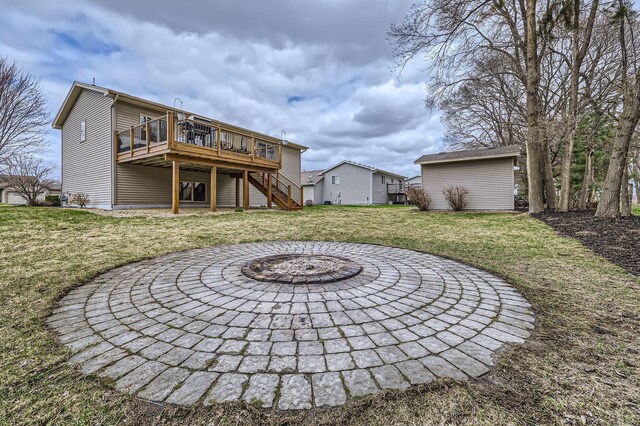 back of house with a wooden deck, a yard, stairs, and an outdoor fire pit
