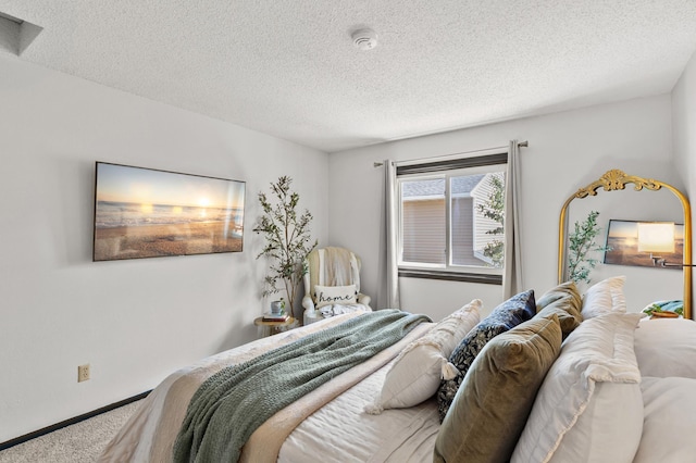 bedroom with carpet, a textured ceiling, and baseboards