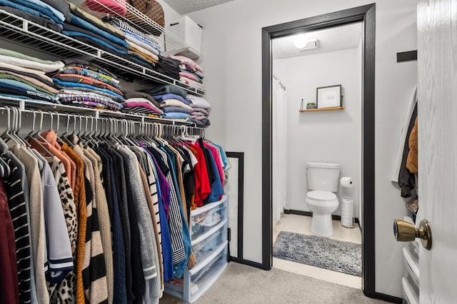walk in closet with tile patterned flooring