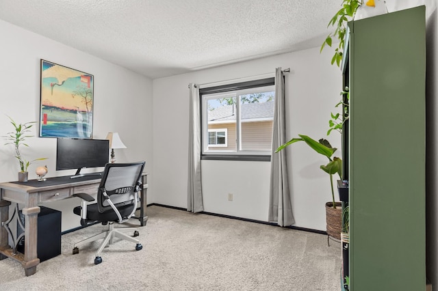 carpeted home office featuring a textured ceiling and baseboards