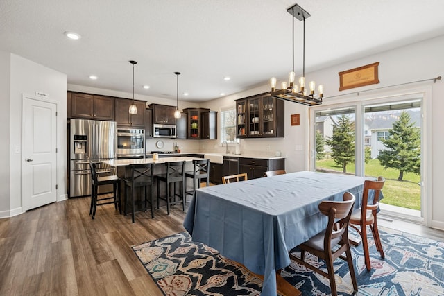 12985 Legacy Creek Pkwy NE, Blaine, MN 55449 - dining room with dark wood-style flooring, recessed lighting, and a chandelier