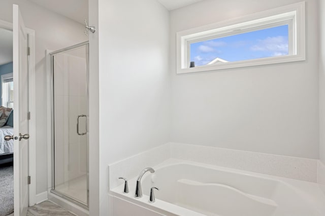 12985 Legacy Creek Pkwy NE, Blaine, MN 55449 - ensuite bathroom featuring healthy amount of natural light, a shower stall, and a bath