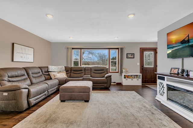 living room with recessed lighting, dark wood finished floors, and a wealth of natural light