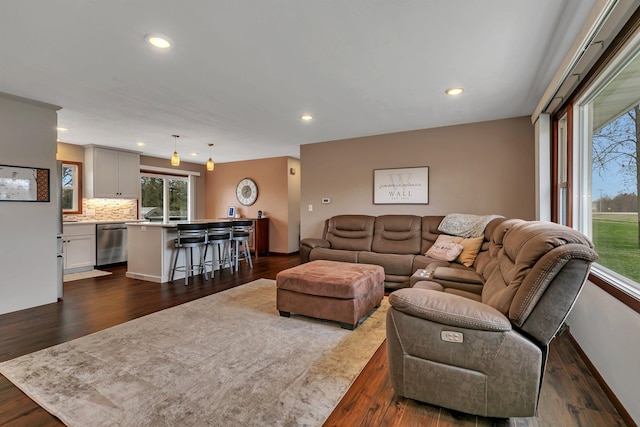 living area with recessed lighting and dark wood finished floors