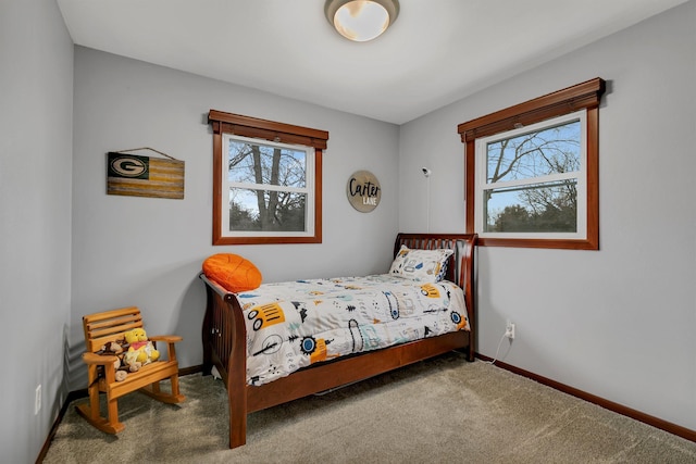 carpeted bedroom with baseboards and multiple windows