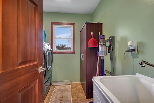 clothes washing area featuring independent washer and dryer, laundry area, a sink, baseboards, and visible vents