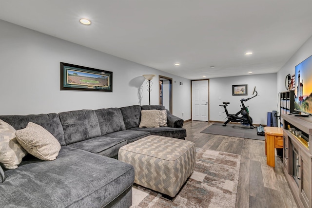 living area with recessed lighting, visible vents, and light wood-style floors