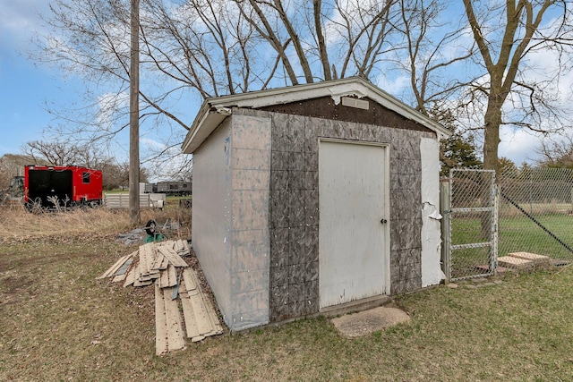 view of shed with fence and a gate