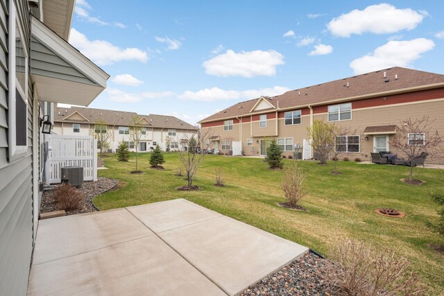 view of yard with a patio, central AC unit, and a residential view