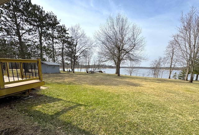 view of yard with a deck with water view