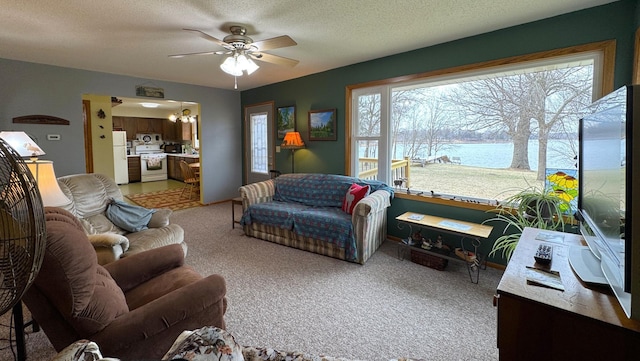 living room featuring plenty of natural light, light colored carpet, a textured ceiling, and ceiling fan