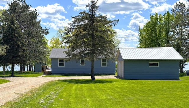 36777 311th Ln, Aitkin, MN 56431 - back of house with an outdoor structure, a yard, and driveway