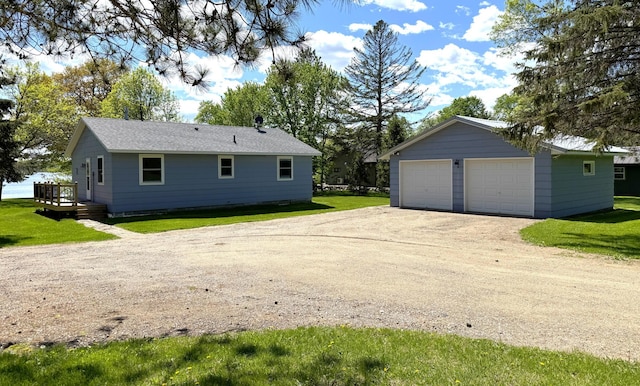 36777 311th Ln, Aitkin, MN 56431 - view of home's exterior with a detached garage, a lawn, an outdoor structure, and a wooden deck