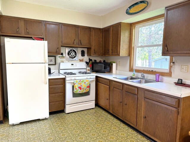 36777 311th Ln, Aitkin, MN 56431 - kitchen with white appliances, a sink, and light countertops