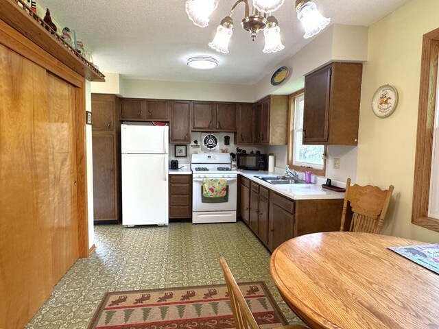 36777 311th Ln, Aitkin, MN 56431 - kitchen featuring white appliances, a sink, a chandelier, light countertops, and tile patterned floors