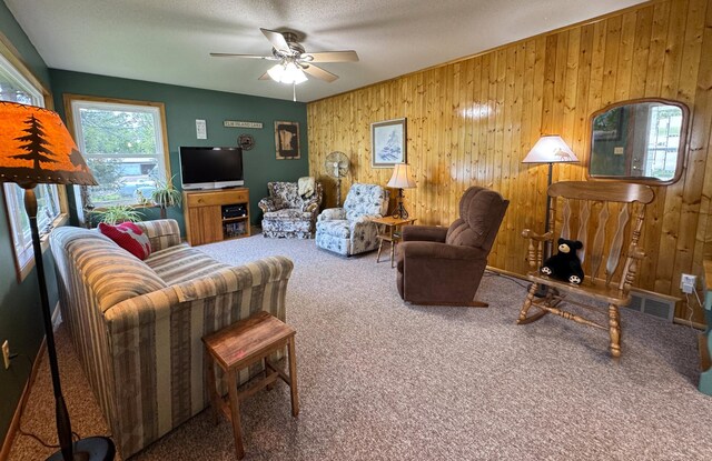 36777 311th Ln, Aitkin, MN 56431 - living room featuring carpet, wooden walls, and ceiling fan