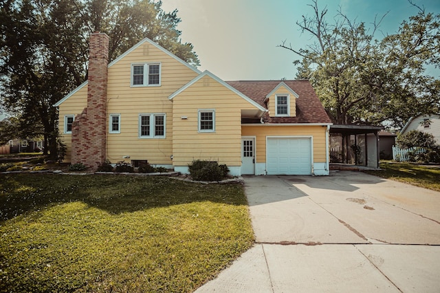 800 5th Ave SW, Austin, MN 55912 - traditional-style house with a front lawn, concrete driveway, a chimney, an attached garage, and a shingled roof