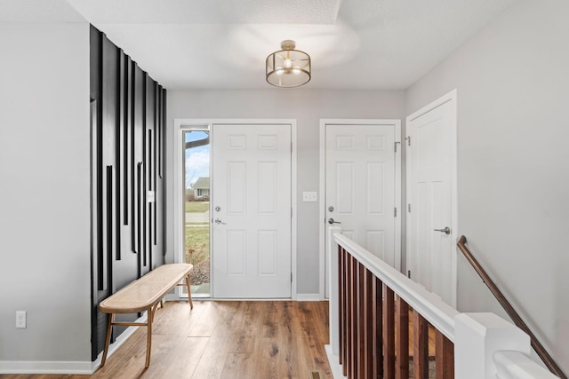 907 7th Ave, Wanamingo, MN 55983 - foyer with wood finished floors, baseboards, and a chandelier