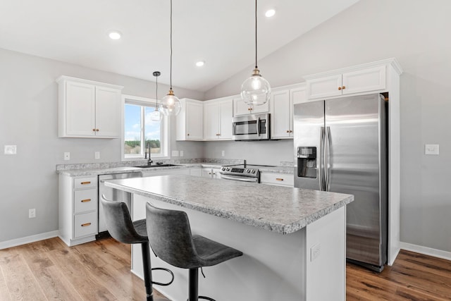 907 7th Ave, Wanamingo, MN 55983 - kitchen featuring stainless steel appliances, a sink, lofted ceiling, white cabinets, and recessed lighting