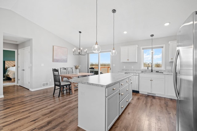 907 7th Ave, Wanamingo, MN 55983 - kitchen featuring appliances with stainless steel finishes, a sink, lofted ceiling, dark wood-type flooring, and light countertops