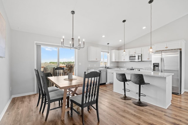 907 7th Ave, Wanamingo, MN 55983 - dining room with light wood-style floors, vaulted ceiling, a chandelier, baseboards, and recessed lighting